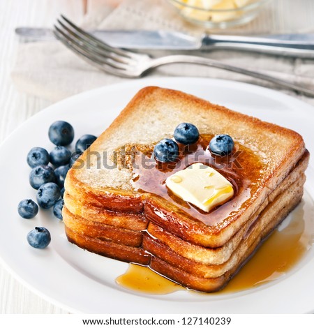 French toast with blueberries, maple syrup and butter