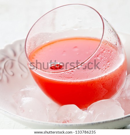 Red juice in glass with ice