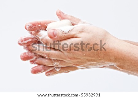 Male hands covered in soap suds on white background