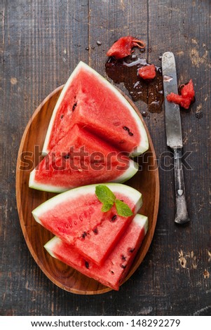 Watermelon slices on wooden background
