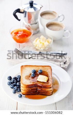 French toast with blueberries, maple syrup and butter
