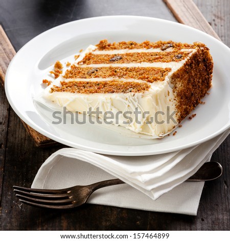 Slice of carrot cake on vintage slate chalk board background