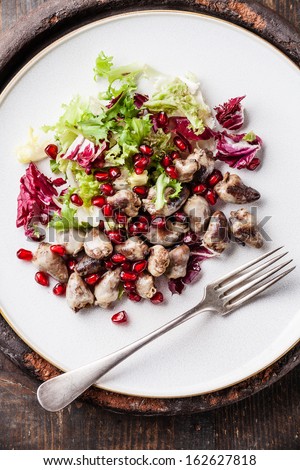 Fried chicken hearts with lettuce and pomegranate