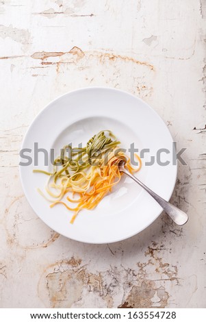 Italian pasta Italian flag colors on white plate