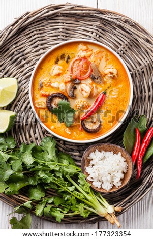 Spicy Thai soup Tom Yam with Coconut milk, Chili pepper and Seafood