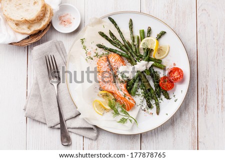 Grilled salmon with asparagus on white wooden background Grilled salmon with asparagus on white wooden background