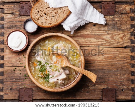 Homemade cabbage soup shchi with sour cream and bread