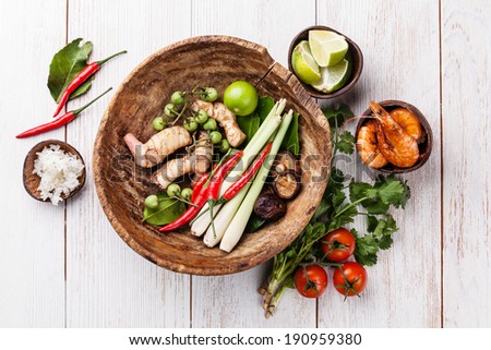 Ingredients for spicy Thai soup Tom Yam with Coconut milk, Chili pepper and Seafood on white wooden background