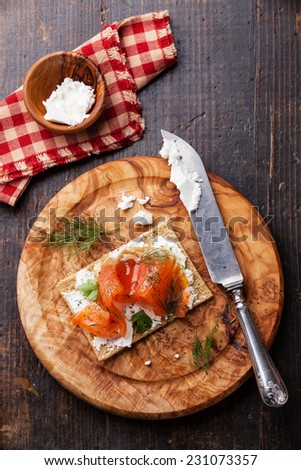 Sandwich on Crisp bread with Smoked salmon and soft Cream cheese on Olive wood plate