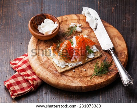 Sandwich on Crisp bread with Smoked salmon and soft Cream cheese on Olive wood plate