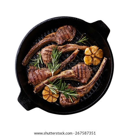 Roasted lamb ribs with rosemary and garlic on grill pan isolated on white background