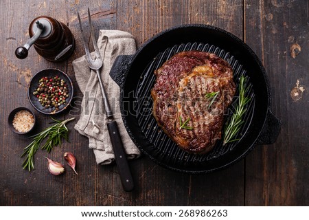Grilled Black Angus Steak on grill iron pan on wooden background