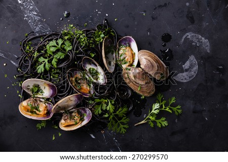 Seafood pasta with clams Spaghetti Vongole on dark marble background
