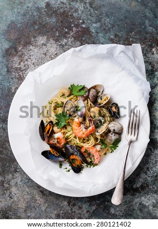 Seafood pasta - Spaghetti with clams, prawns, sea scallops on white plate