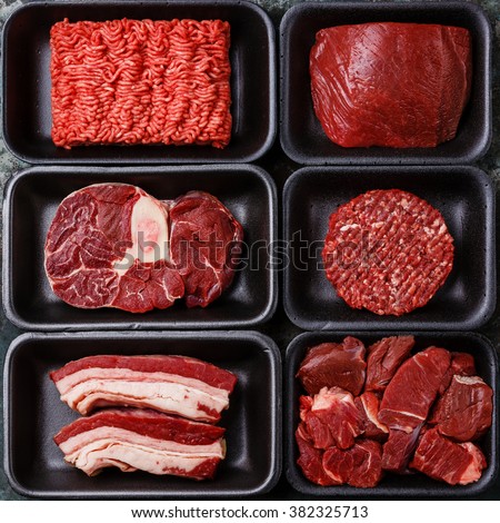 Different types of raw meat in plastic boxes packaging tray