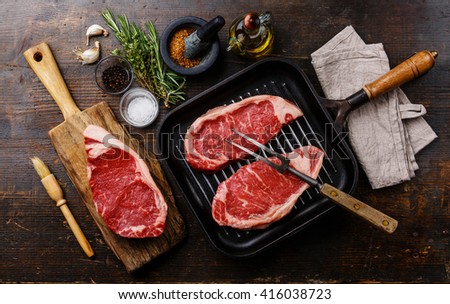 Raw fresh meat Steak Striploin with ingredients and frying Grill pan