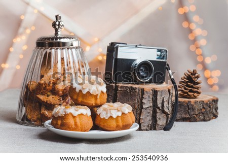 objects on sackcloth bank and cookies with nuts and chocolate cake with a camera