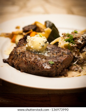 Full plate of food with steak and Gorgonzola butter