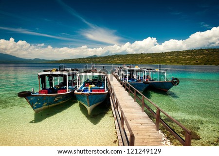 Dive boats wait at the dock on Menjangan Island, Bali, before taking SCUBA tourists out on the magnificent reefs in Bali Barat National Park.