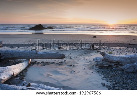 Murphys\' Rock, Arch Cape, Oregon. A beautiful sunset along the Oregon coast with Murphys\' Rock towering over the sandy beach.