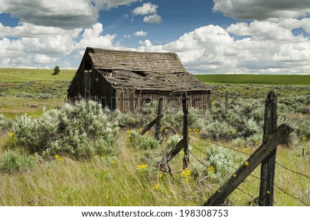 Old Barn. Many of these abandoned barns can be seen along the roadway of the Palouse area of eastern Washington state. Desert surrounds the homestead with sagebrush and grasses for miles.