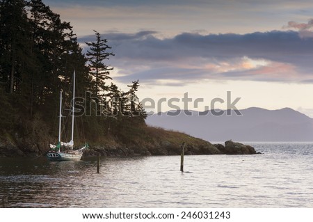 Sailboat at Sunset. A sailboat anchors off of Lummi Island in the San Juan Islands of Puget Sound, Washington state.