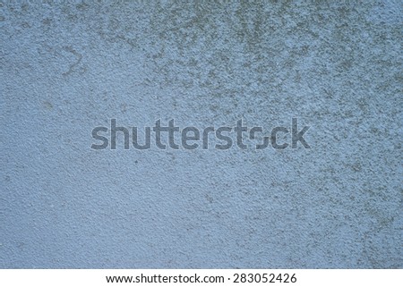 rough, grungy concrete apartment wall texture in blue.