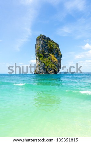 A rock in the sea on a deserted island beach in Thailand