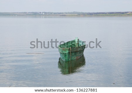 A small wooden boat in the lake
