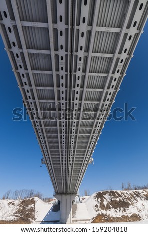 Modern metro bridge in Moscow river runs through the snowy winter day