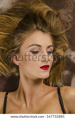 Portrait of a beautiful brown-haired woman with long hair and beautiful makeup.
