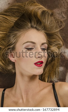 Portrait of a beautiful brown-haired woman with long hair and beautiful makeup.