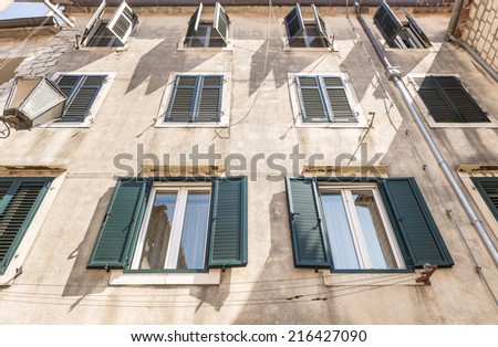 Facade of an old stone house with balconies and shutters in the Venetian style in the town of Kotor. Montenegro
