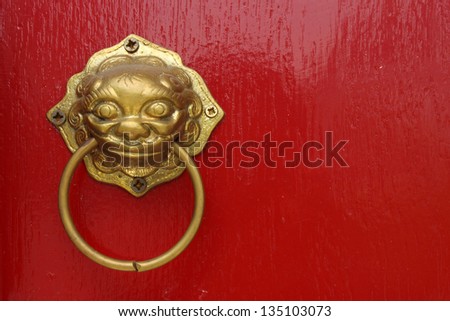 Red chinese door with a lion/dragon head