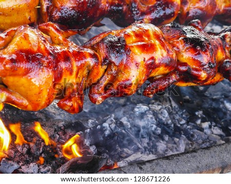 grill chicken cooking on fire charcoal for delicious meal