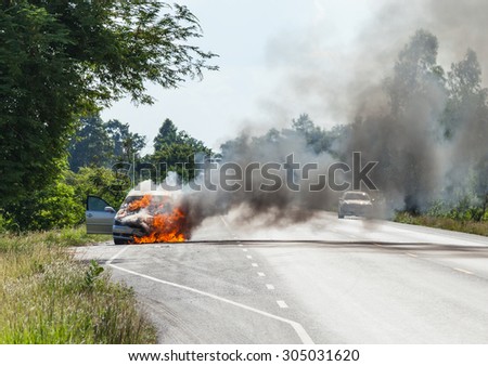 Burning cars on the road.