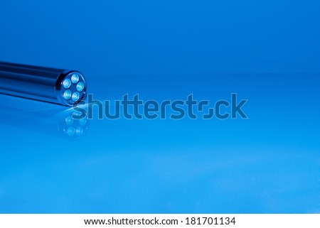 LED torch light on a blue surface