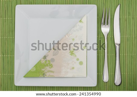 Green, spring-time table setting with napkin