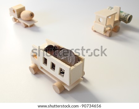 Toy, wooden construction equipment with us currency.