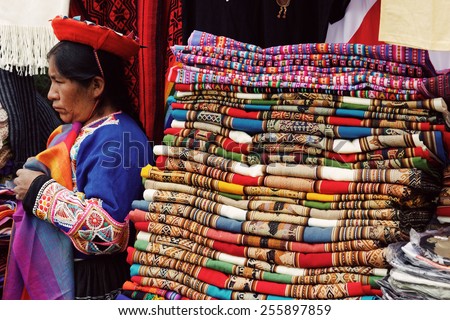 SICUANI, CUSCO/PERU - JANUARY 21, 2013: Peruvian traditional blankets sold by a native woman.
