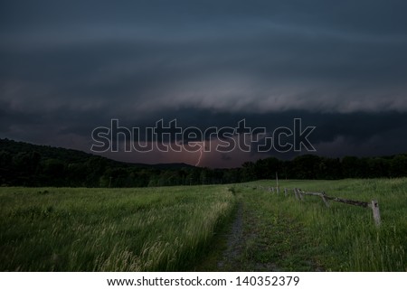 A severe thunderstorm approaches a Hudson valley field.