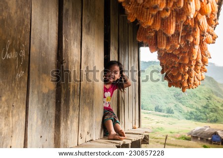MUCANGCHAI, VIETNAM - SEP 22: unidentified ethnic kid relaxing in ethnic\'s house when her parents are working on the terraces on Sep 22, 2014 in Mu Cang Chai, Yen Bai, Vietnam.