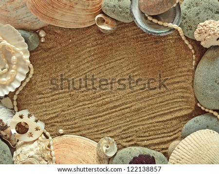The sea frame with decorations on the sand background