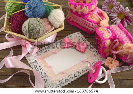 Pink greeting card with baby knitting things