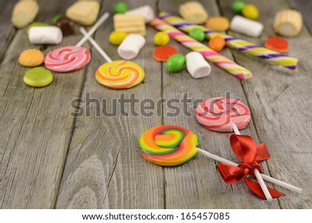 Lollipops with sweet things on the wooden table