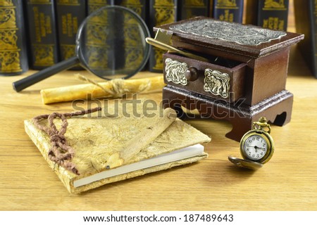 Wooden box with notepad and pocket watch