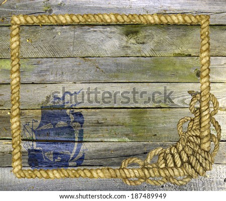 Wooden planks with sea rope frame and ship silhouette