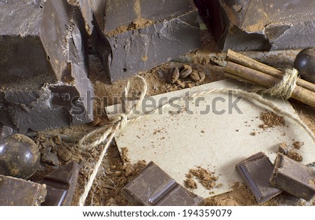 Dark chocolate still life with greeting card and candies