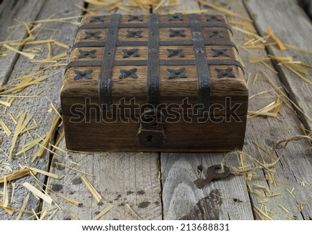 Old box with lock on the wooden background