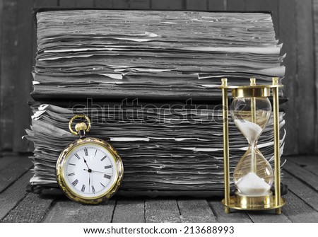 Still life with pocket watch and sand clock on wooden background, black and white style